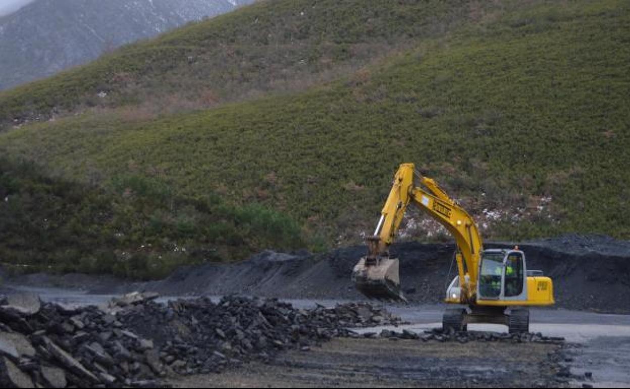 La excavadora trabaja en la retirada de la plataforma de hormigón en la Campa de Tormaleo, en 2019. / 