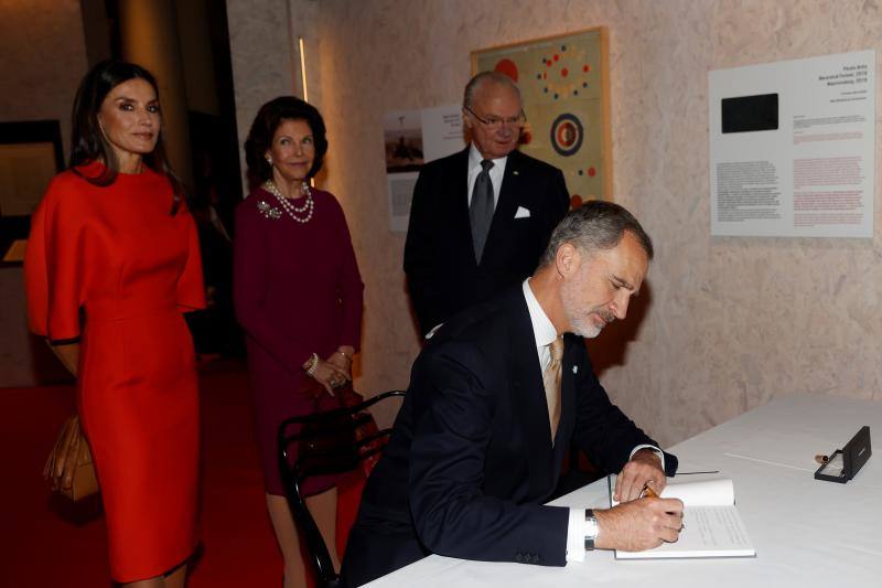 El Rey Felipe VI firma en el libro del Museo Nobel de Estocolmo, en presencia de la Reina Letizia y de los monarcas suecos, Carlos Gustavo (d) y Silvia (c), con motivo de su visita a la exposición de dibujos del médico español Santiago Ramón y Cajal, quien recibió el prestigioso galardón en Medicina en 1906.