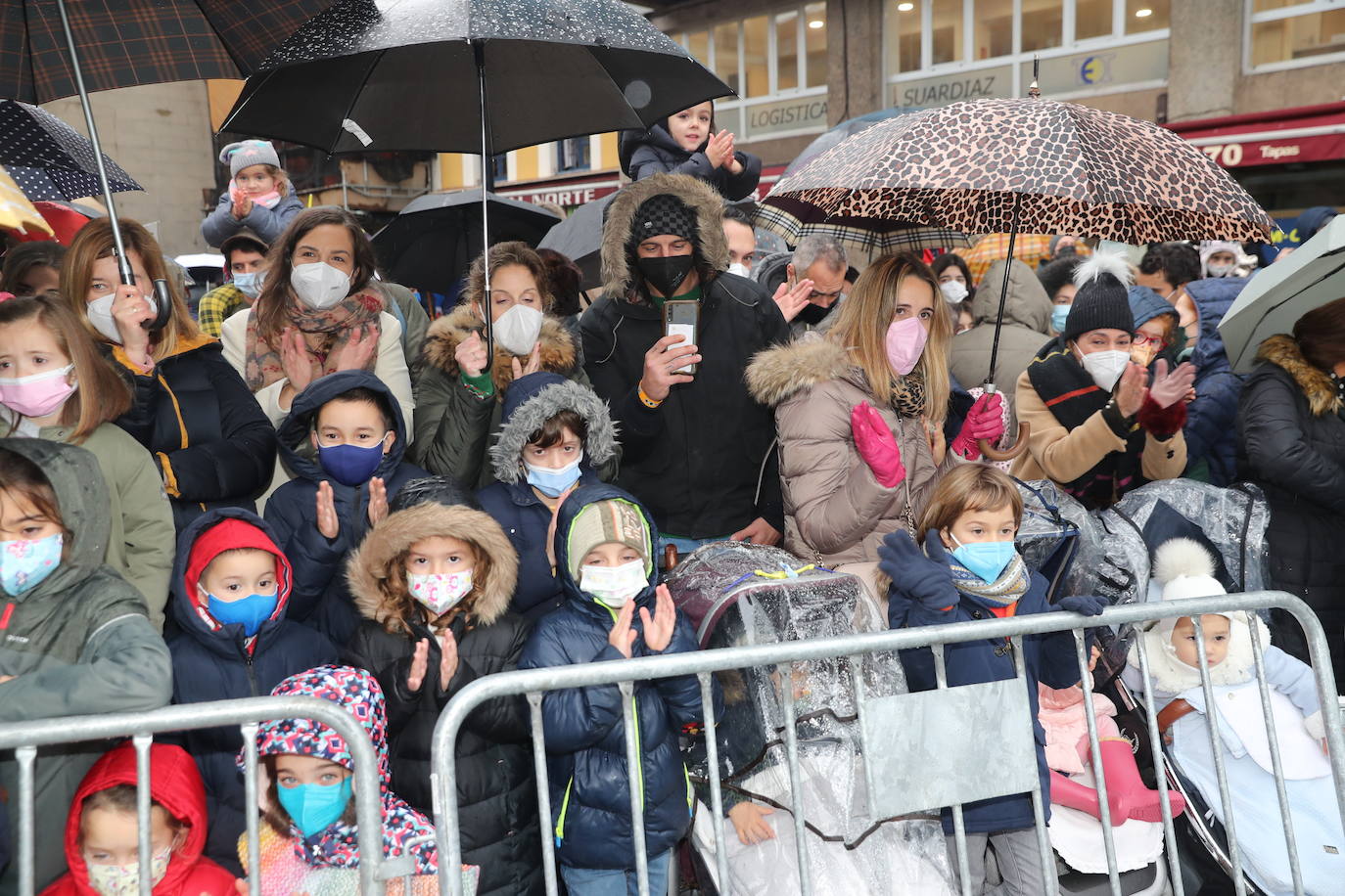 Los Reyes Magos atracaban en el puerto de Gijón bajo la lluvia sobre las 11 de la mañana mientras centenares de niños coreaban lo nombres de Sus Majestades.