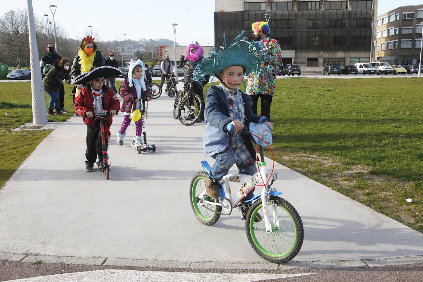 Los más pequeños lucen los disfraces de Carnaval subidos en las bicicletas y monopatines.