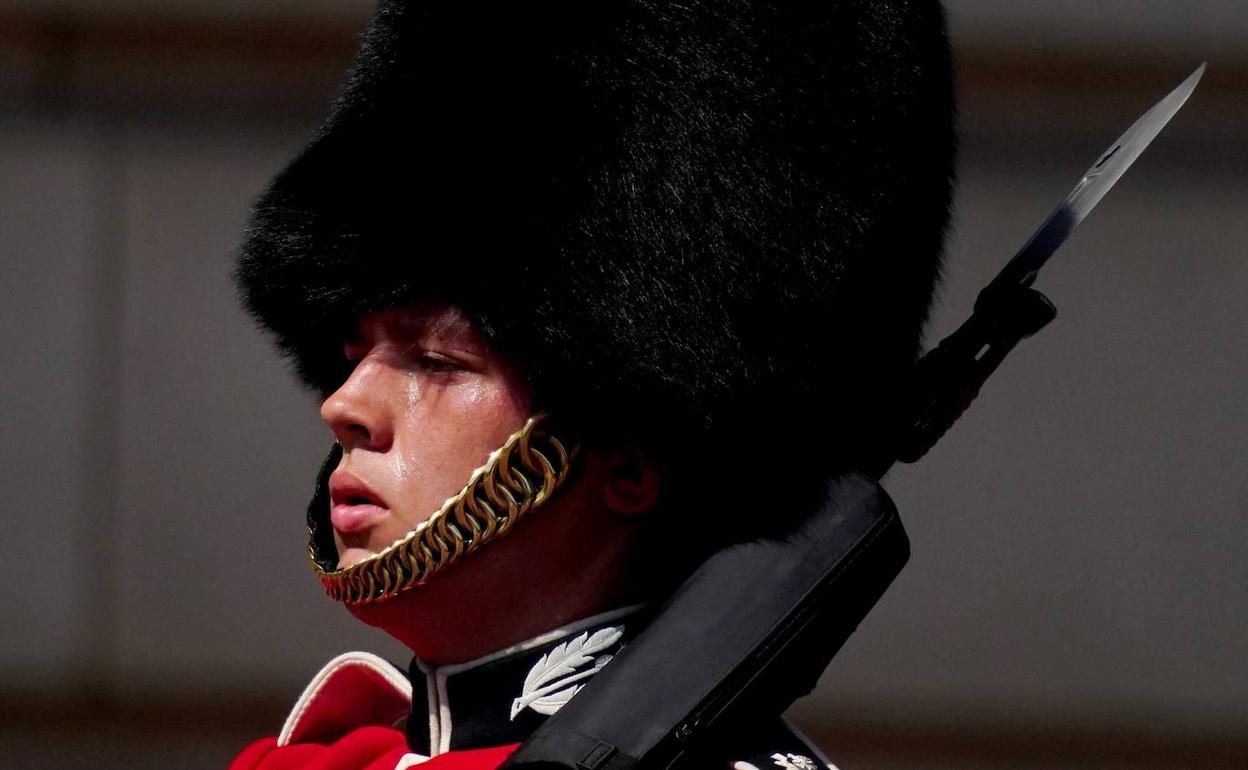 Un guardián de Buckingham Palace suda por las altas temperaturas, que este martes han batido el récord histórico en Reino Unido