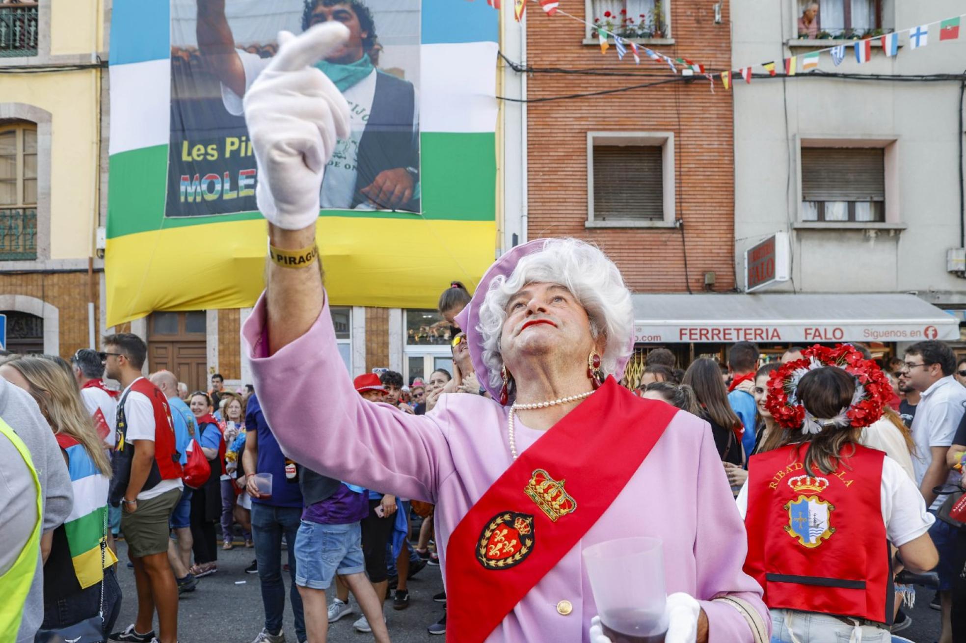 Interés Turístico Internacional.Una peculiar Reina de Inglaterra, calimocho en mano, saluda a las autoridades con el gran cartel de el Mole tras ella. 