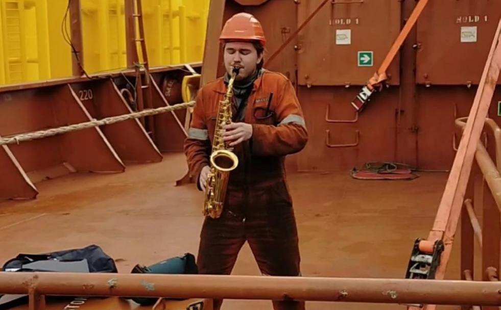 Nikita, con su saxofón a bordo del barco amarrado en Avilés. 