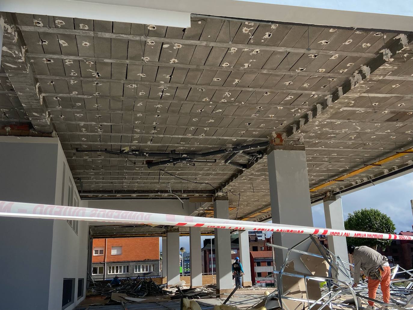 El viento derriba el falso techo de un soportal de la calle Xuacu de la Sama, en Oviedo. 