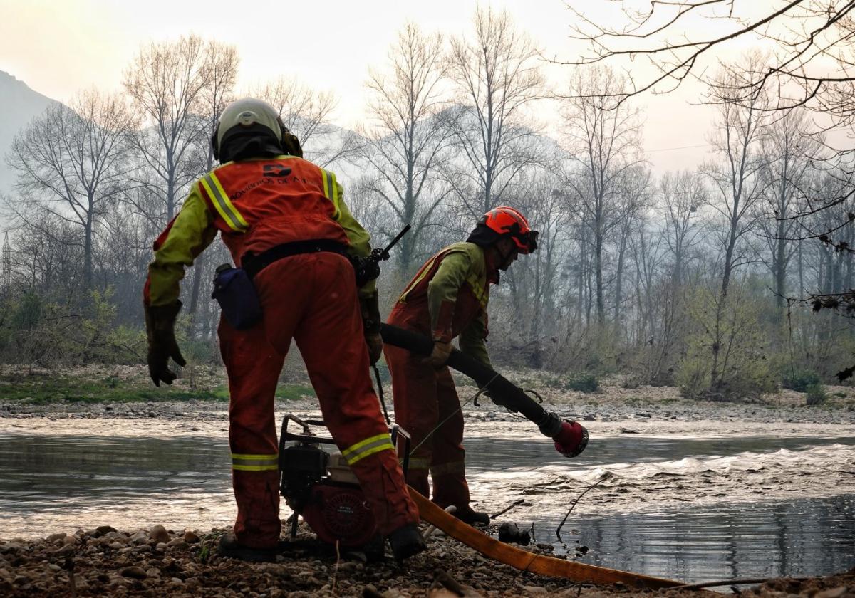 Bomberos cargan agua en el río Sella.