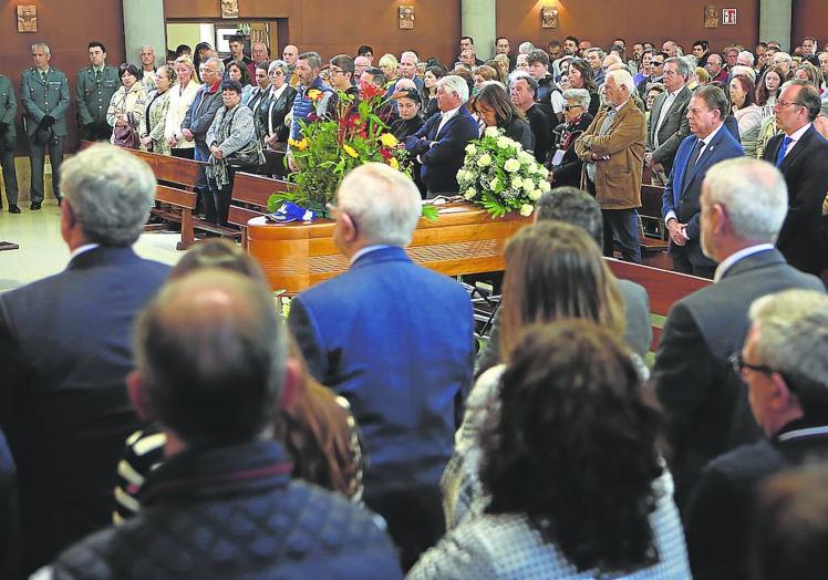 Imagen principal - Foto 1. Cientos de personas llenaron la iglesia de San Melchor de Quirós, en el barrio ovetense de Vallobín, para despedir a Francisco Javier Álvarez. En primera fila, junto a otros miembros de la corporación local, el alcalde de la ciudad, Alfredo Canteli. | Foto 1. Decenas de vecinos y amigos de Julio César Castrillo acudieron a su funeral enBáscones. | Foto 3. La viuda de Francisco Javier, Belinda Tamargo, recibe el pésame de sus compañeros de la Guardia Civil. 