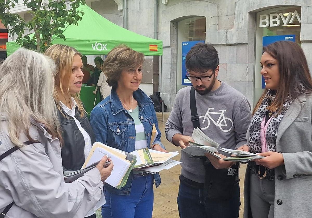 López (a la derecha) entrega propaganda en Avilés.
