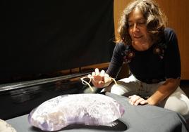 Laura Viñuela muestra la pieza, en la que se puede ver el pez en su interior.