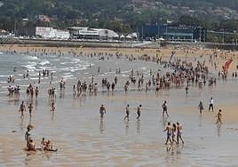 La playa de San Lorenzo, este martes, sirvió de refugio a miles de personas contra el calor.