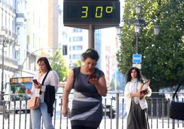 Un termómetro marca 30 grados en una calle de Oviedo este lunes.