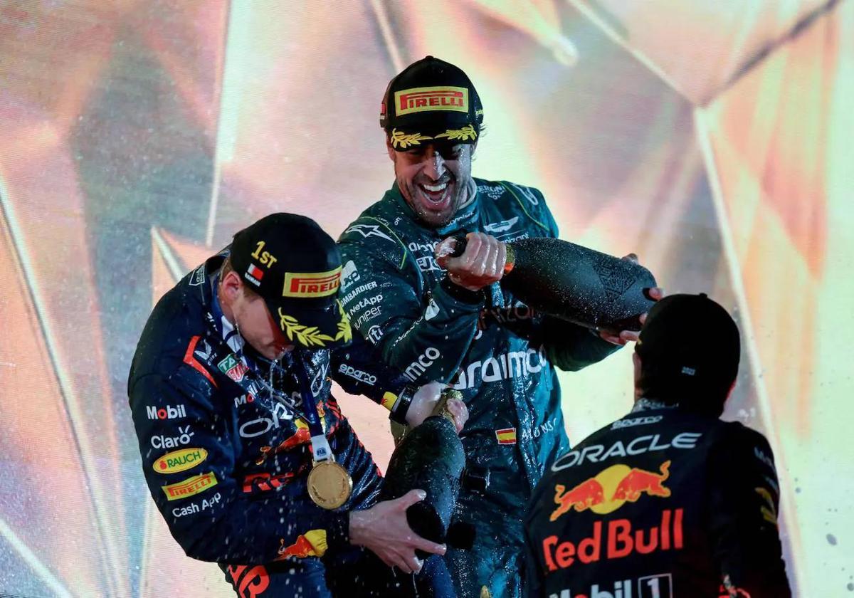 Fernando Alonso celebra un podio con los dos pilotos de Red Bull el curso pasado.