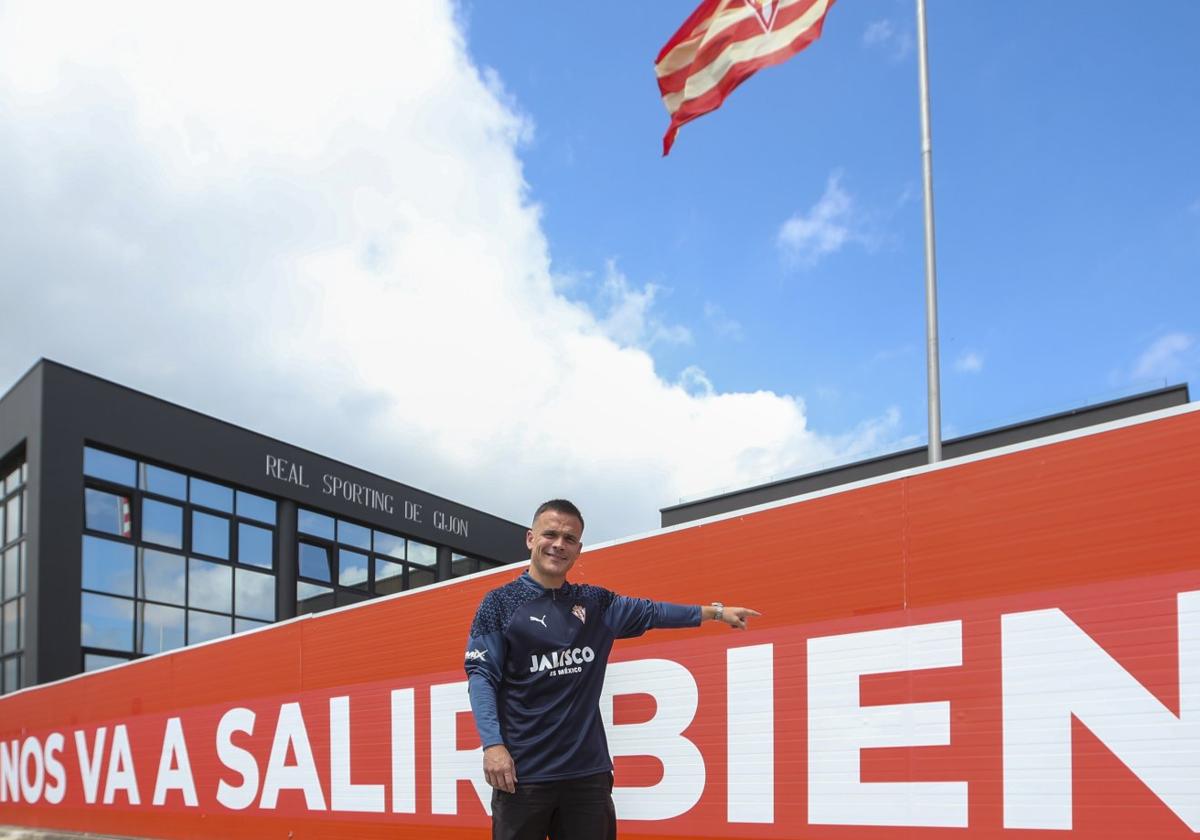 El canario Roque Mesa, autor del gol de la clasificación del Sporting al 'play off' el domingo en Elda, ayer, posando para EL COMERCIO delante de la valla que lleva impreso el lema del sportinguismo.