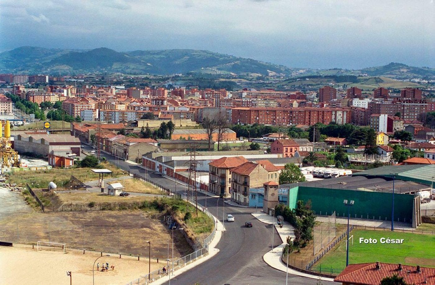 Casa Dulce, al fondo de la avenida, fue una institución por su pulpo amariscado. En primer término se ve el campo de arena que se hizo hacia 1996 dentro de El Musel y enfrente, el del Puerto con el frontón.