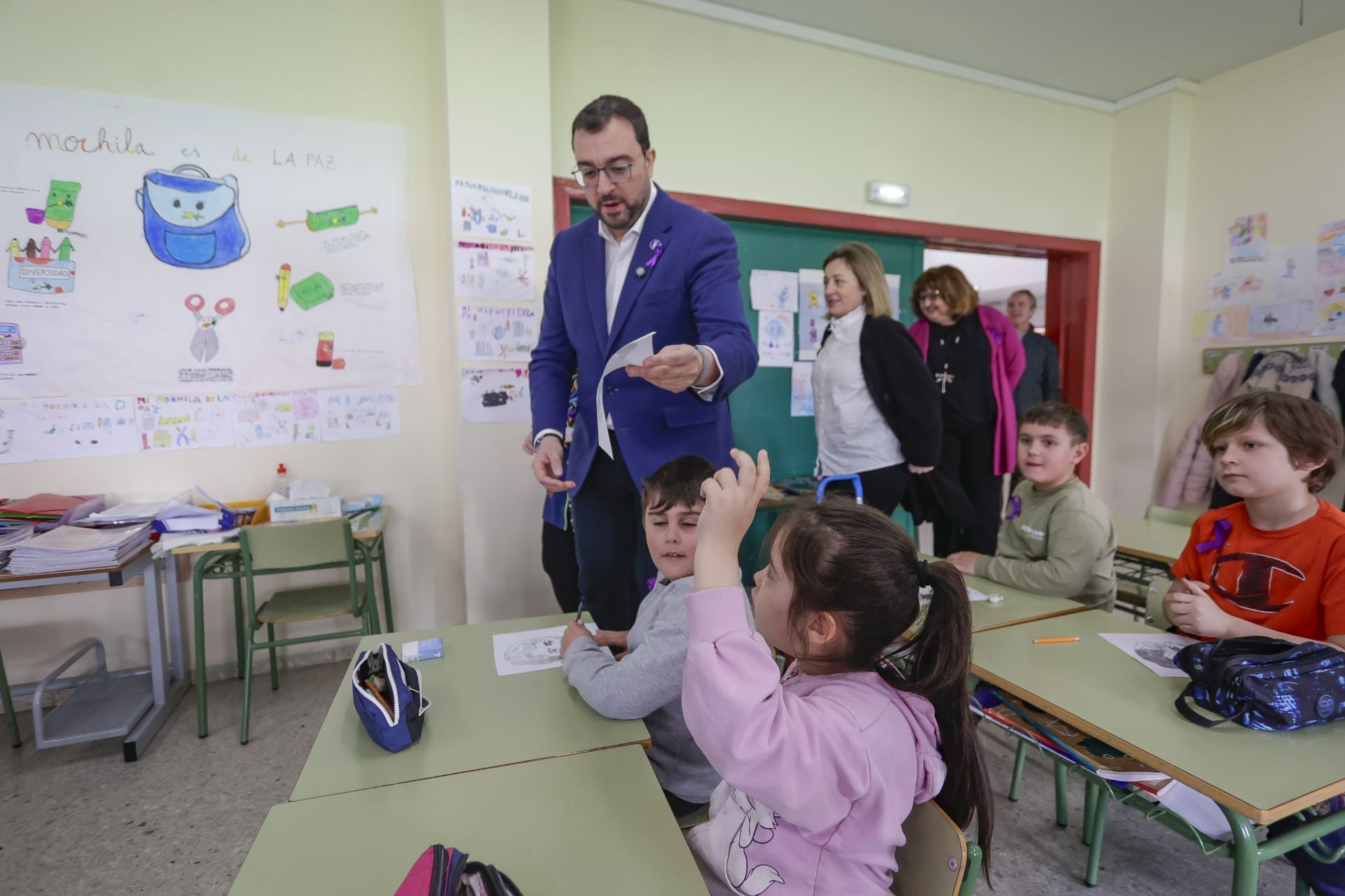 Una alumna entrega a Adrián Barbón su dibujo con el rostro de la poeta gallega Rosalía de Castro