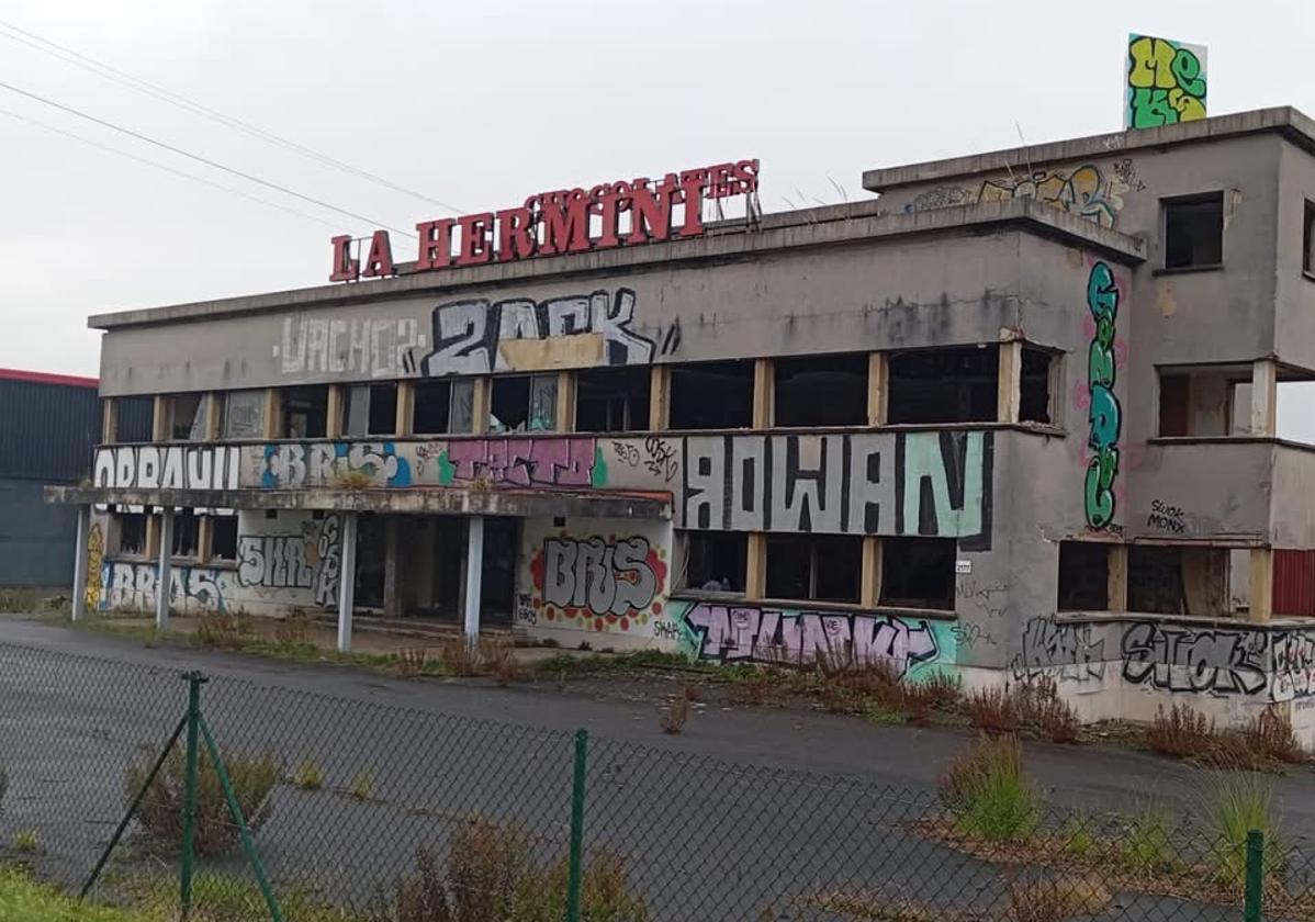Estado actual de la antigua fábrica de Chocolates La Herminia de Porceyo, en Gijón, con su fachada cubierta de grafitis.