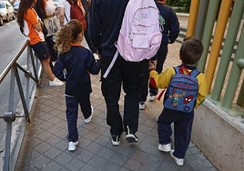 Un padre lleva a sus hijos al colegio hoy, en Madrid. En la capital los colegios están abiertos, pero sin actividad docente.