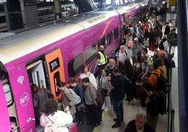 Pasajeros en la estación de Oviedio acceden a uno de los trenes que este martes salió hacia Madrid.