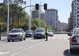 Un policía local, regulando el tráfico en Gijón durante el apagón del lunes.