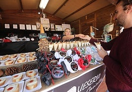 Un cliente compra queso en una de las casetas de la Feria del Queso y el Vino de Avilés del año pasado.