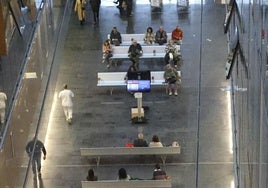 Pacientes y compañantes en una sala de espera del HUCA, uno de los tres hospitales universitarios de referencia de Asturias.