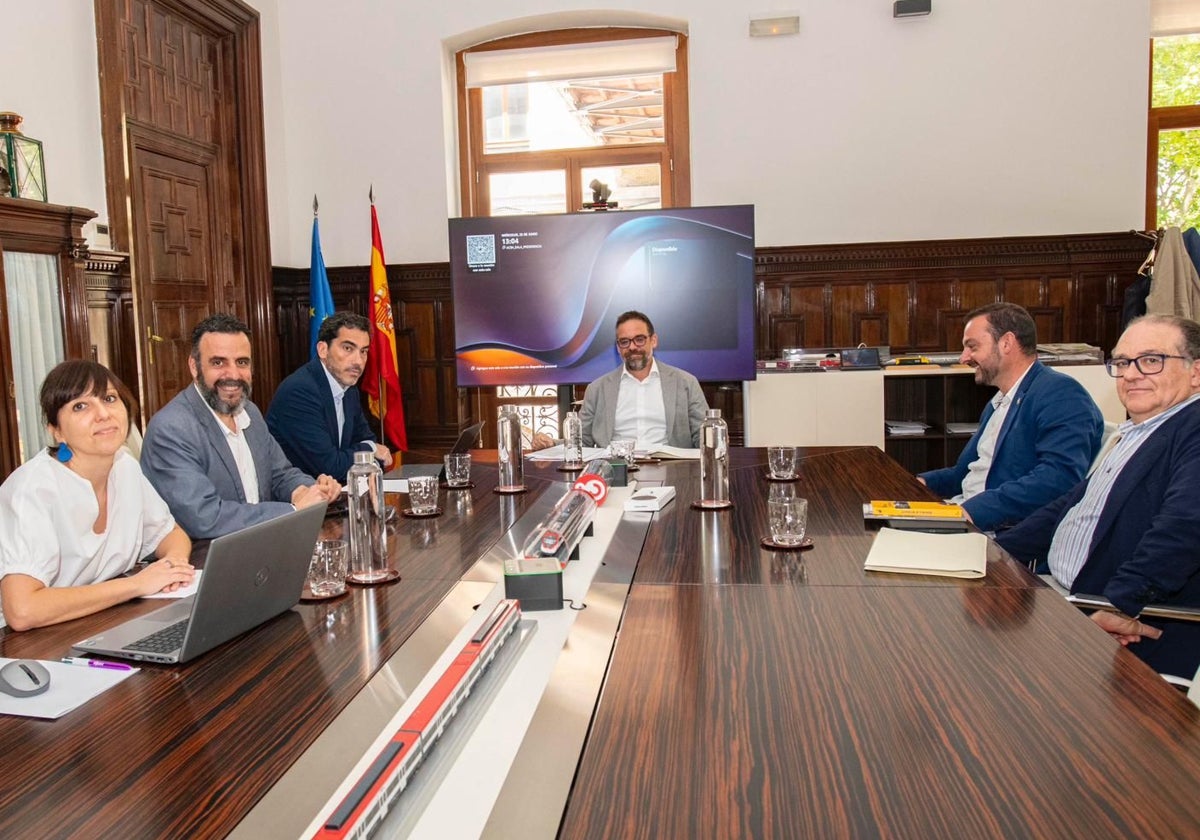 El alcalde de Mieres y el director del Museo del Ferrocarril, a la derecha, en la reunión con el presidente de Renfe, en el centro.