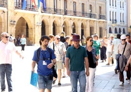 Un guía acompaña de un grupo de turistas en la plaza de la Constitución este viernes.