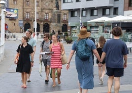 Un grupo de turistas pasea por el Puerto Deportivo hacia las 'Letronas', uno de los principales reclamos turísticos de Gijón.