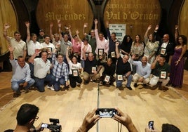 Ganadores históricos del Campeonato regional de Escanciadores y autoridades simulan echar un culín en Sidra Menéndez, en Gijón.
