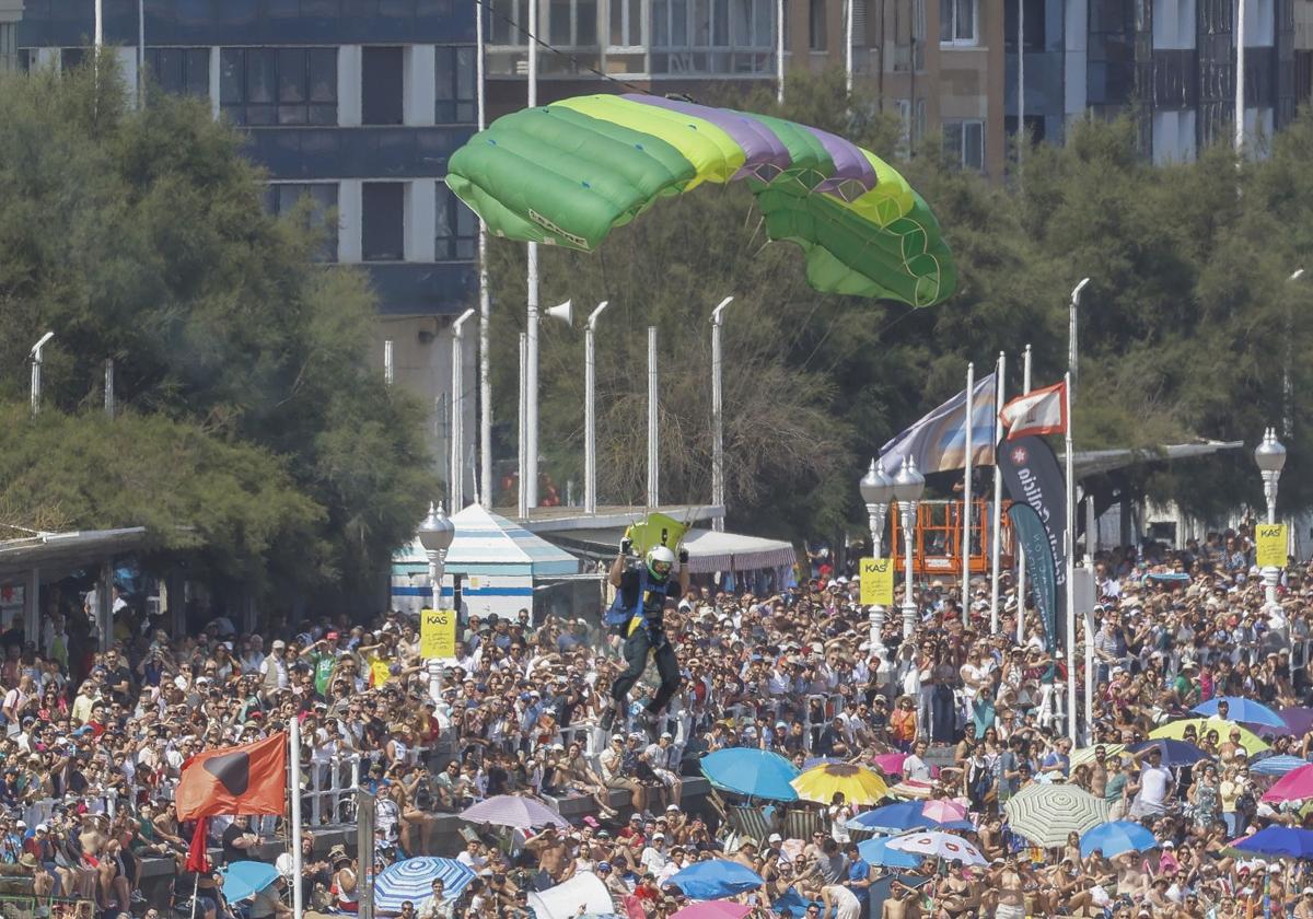 Miles de personas observaban asombradas la dificultosa maniobra de aterrizaje de un paracaidista en la zona acotada para ello en la playa de San Lorenzo.