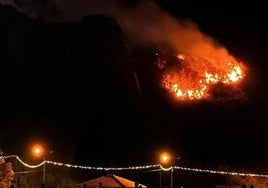 Dos personas observando el incendio en Candás ayer.