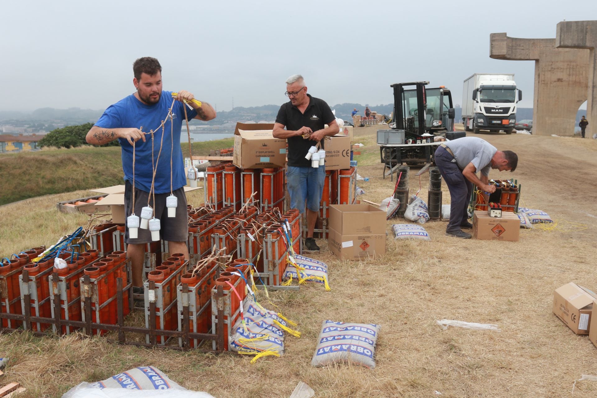 Empleados de Pirotecnia Zaragonzana ultiman el montaje del material pirotécnico que iluminará Gijón.