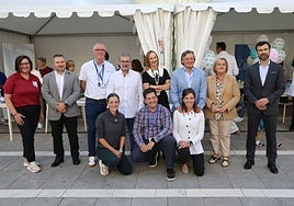 Los representantes de colegios profesionales y asociaciones con la concejala Lourdes García, de rodillas en el centro.