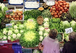 Dos mujeres compran frutas y verduras.