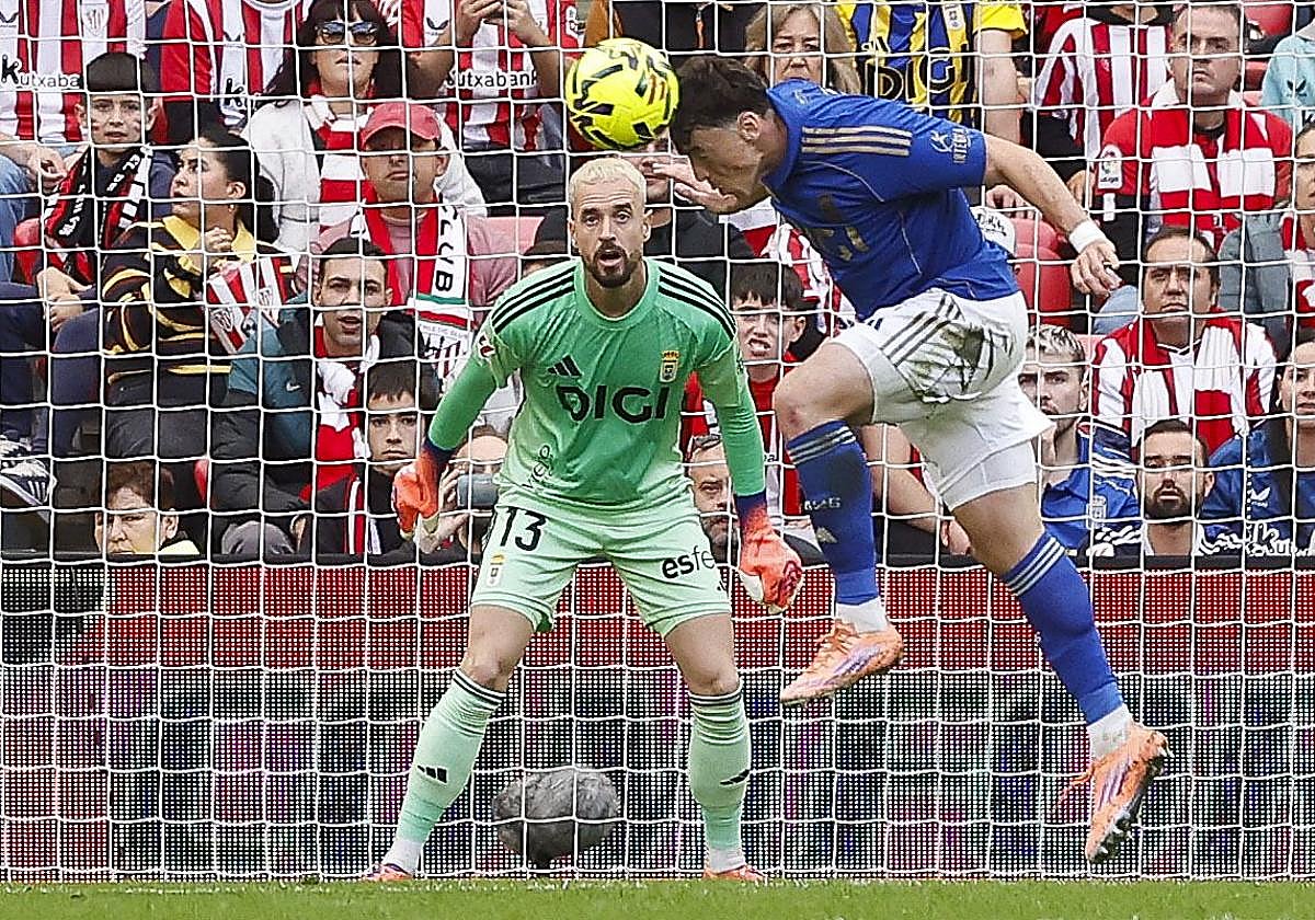 El delantero Fede Viñas despeja en el área un saque de esquina ante la mirada de Aarón Escandell.