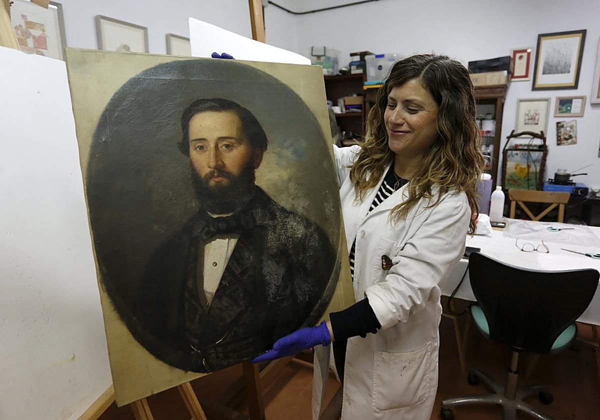 Laura Rodríguez sostiene una de las obras.