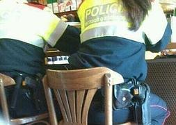 Una pareja de mossos en la barra de un bar. En la pistola que lleva uno de ellos se puede ver una 'estelada'. / Archivo