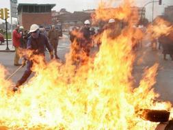 Trabajadores de Naval Gijón, esta mañana, tras una de las barricadas que han montado en protesta por el ERE / P. CITOULA
