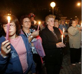 Vecinos de La Camocha se concentran con velas en señal de apoyo a los mineros encerrados. / UCHA