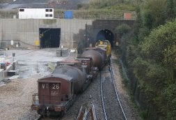 Un convoy con torpedos regresaba ayer a Gijón desde Avilés; a la izquierda, el túnel nuevo ya terminado. / MARIETA