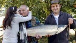 Sandra, hija de Gonzalo Álvarez, felicita a su padre tras capturar el campanu. Junto a ellos, Hugo, sobrino del pescador./ EFE