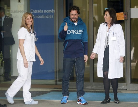 Fernando Alonso, acompañado del personal médico que le atendió en el Hospital General de Barcelona, tras ser dado de alta. 