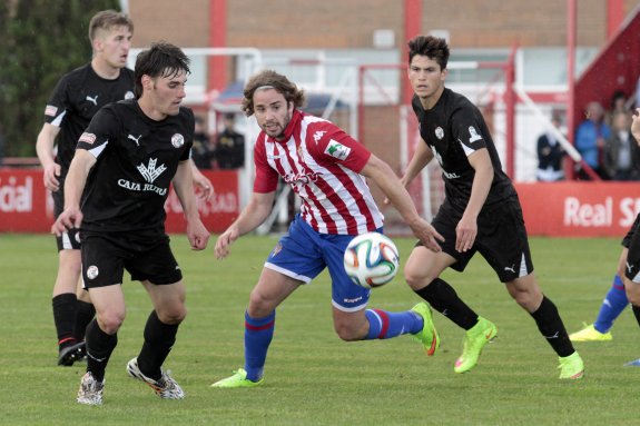 El rojiblanco Mendi pelea por un balón rodeado de jugadores del Zamora. 