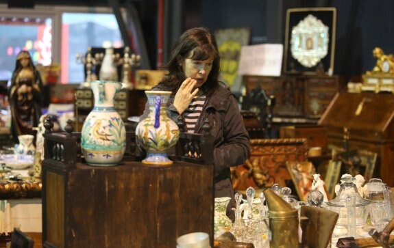Una mujer observa piezas de cristal en uno de los expositores. 