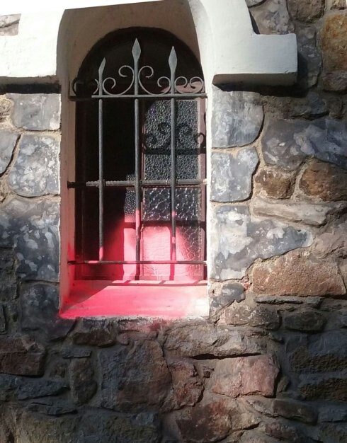 Una de las ventanas pintadas con spray rojo. 