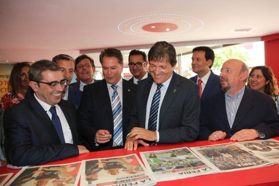 Marcelino Gutiérrez, Félix Baragaño, Javier Fernández, en primer término, y José María González, presidente del consejo de Administración de El Comercio, observan varios ejemplares del Diario de la Feria en el estand de EL COMERCIO. 