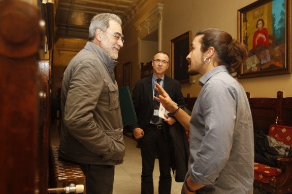 Manuel Matallanas, exgerente del HUCA, conversa con el diputado de Podemos, Andrés Fernández Vilanova, en presencia del director de La Cadellada, Pablo Fernández, durante un descanso de la comisión de investigación de listas de espera de la Junta General. 