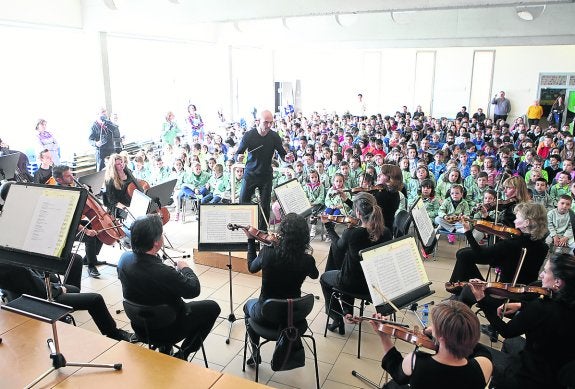 Omar Navarro, batuta en mano, dirige a sus músicos ante la espectación de los pequeños. 