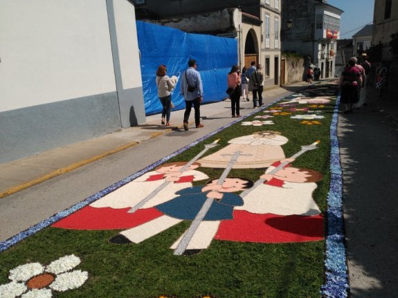 Alfombra floral en la calle Campo con los niños vestidos de comunión. 