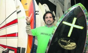 Hiucif, que pertenece a una agrupación cristiana apoyada en el surf, con una de sus tablas favoritas, en su local de Mareo. ::                             PALOMA UCHA