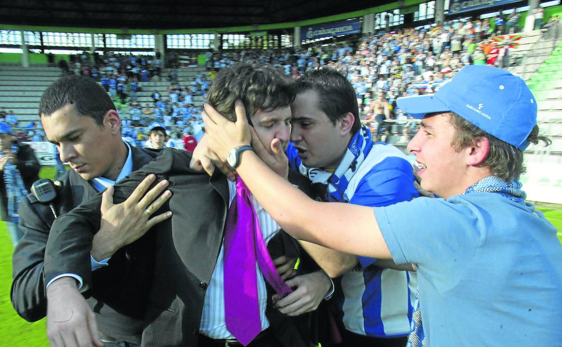 Consuelo y alivio. Fernando Ortiz de Zárate recibe el cariño de dos hinchas al acabar el partido de Vigo que mantuvo al Alavés en Segunda.